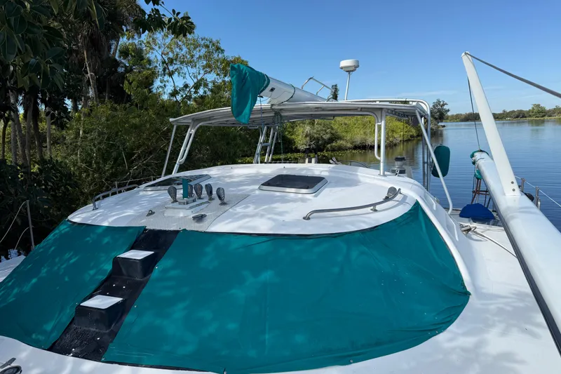 Slide: The Image of 1995 Manta SAILING CATAMARAN docked by lush greenery and calm waters. - 4