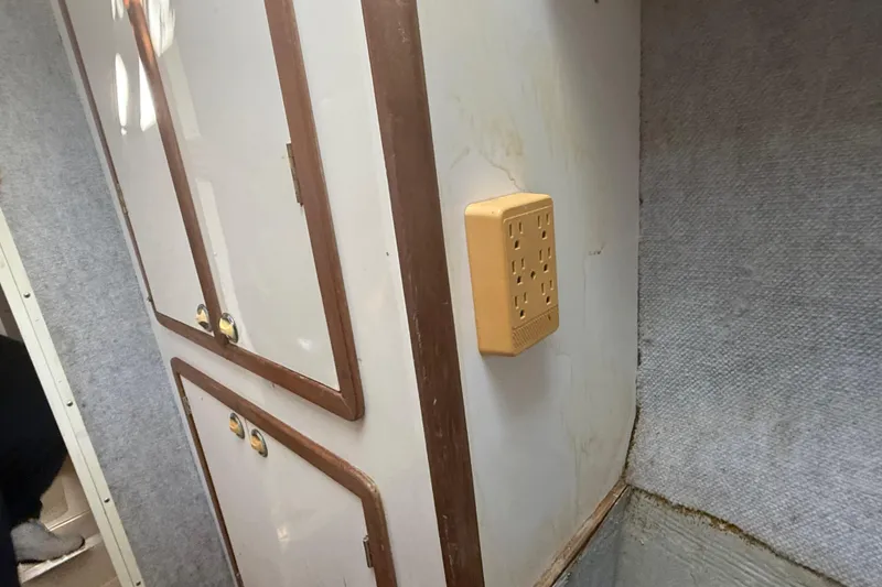 Slide: The Image of Interior of 1995 Manta Sailing Catamaran with cabinets and electrical outlet. - 42