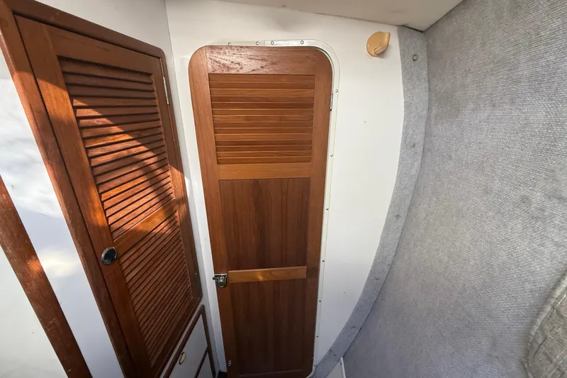 Slide: The Image of Interior of 1995 Manta SAILING CATAMARAN with wooden doors and carpeted walls. - 46