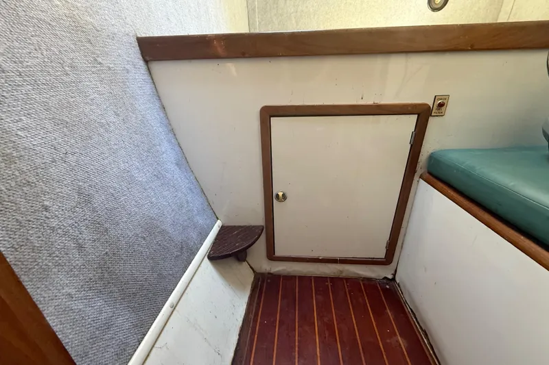 Slide: The Image of Interior of 1995 Manta Sailing Catamaran with wooden floor and small storage door. - 47