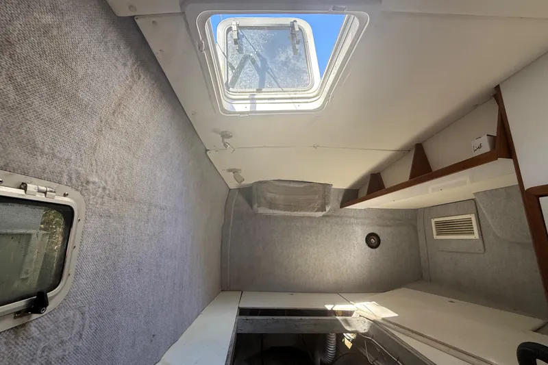 Slide: The Image of Interior cabin of a 1995 Manta Sailing Catamaran with skylight and storage shelves. - 48