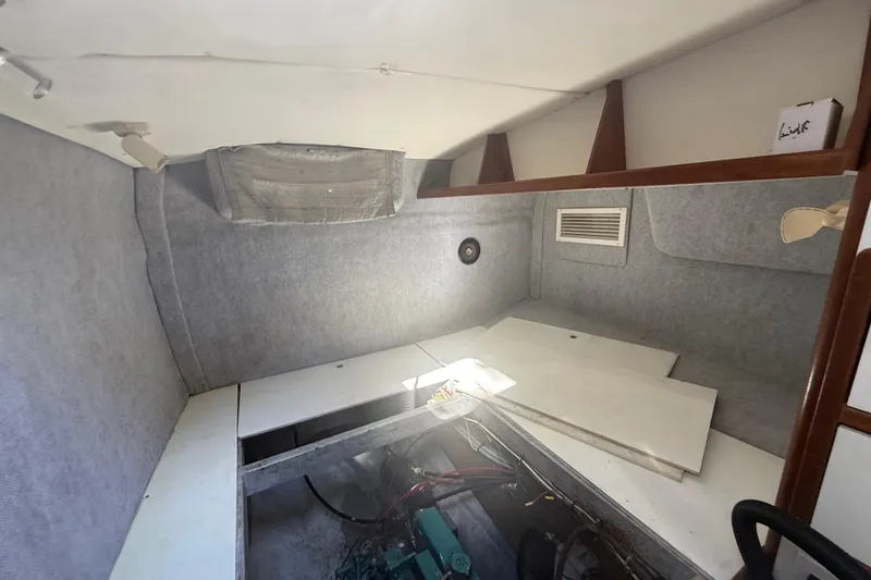 Slide: The Image of Interior of a 1995 Manta SAILING CATAMARAN, featuring a compact cabin space with storage. - 49