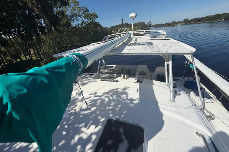 Slide: The Image of 1995 Manta SAILING CATAMARAN on calm water, featuring deck and mast view. - 5