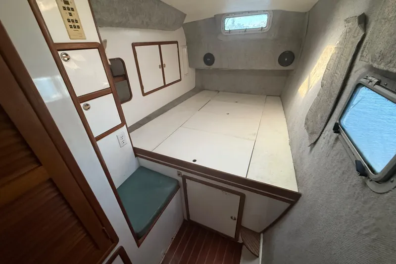 Slide: The Image of Interior of 1995 Manta SAILING CATAMARAN cabin with bed, storage, and windows. - 53