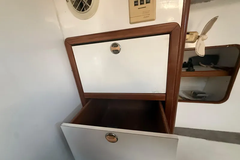 Slide: The Image of Interior storage compartment on a 1995 Manta SAILING CATAMARAN with wooden trim and ventilation. - 56