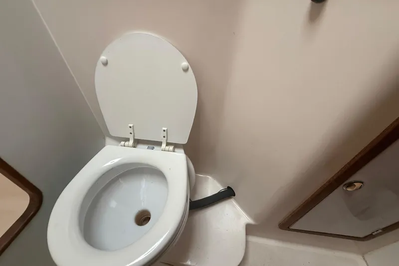 Slide: The Image of Toilet in 1995 Manta SAILING CATAMARAN bathroom, white interior, compact design. - 63