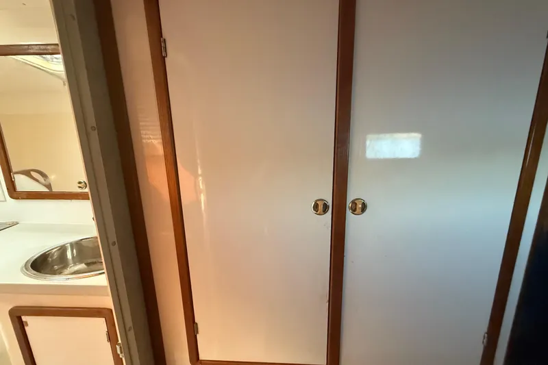 Slide: The Image of Interior of 1995 Manta Sailing Catamaran with wooden cabinets and stainless steel sink. - 66