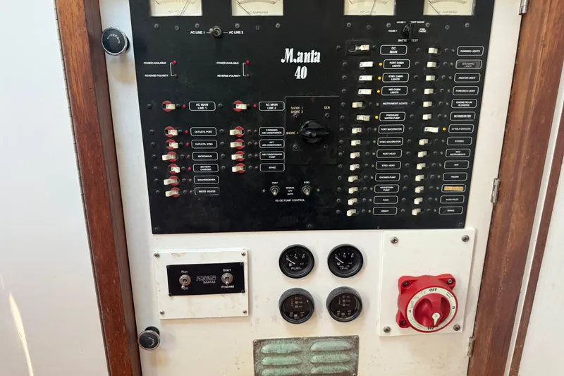 Slide: The Image of Electrical control panel of a 1995 Manta SAILING CATAMARAN, featuring switches and gauges. - 70