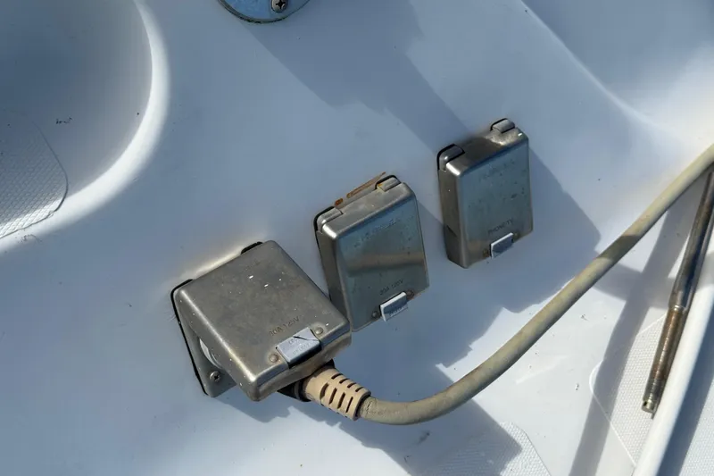 Slide: The Image of Electrical outlets on a 1995 Manta SAILING CATAMARAN deck, featuring protective covers. - 76