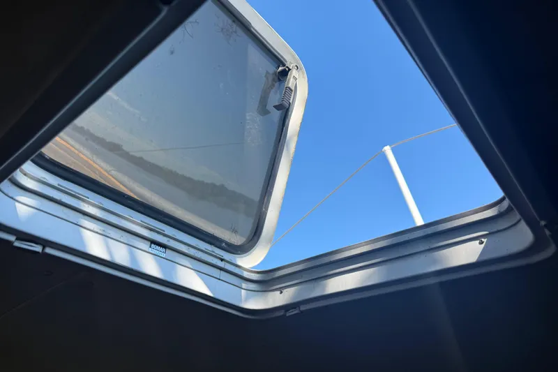 Slide: The Image of Open hatch on 1995 Manta Sailing Catamaran, revealing clear blue sky. - 77
