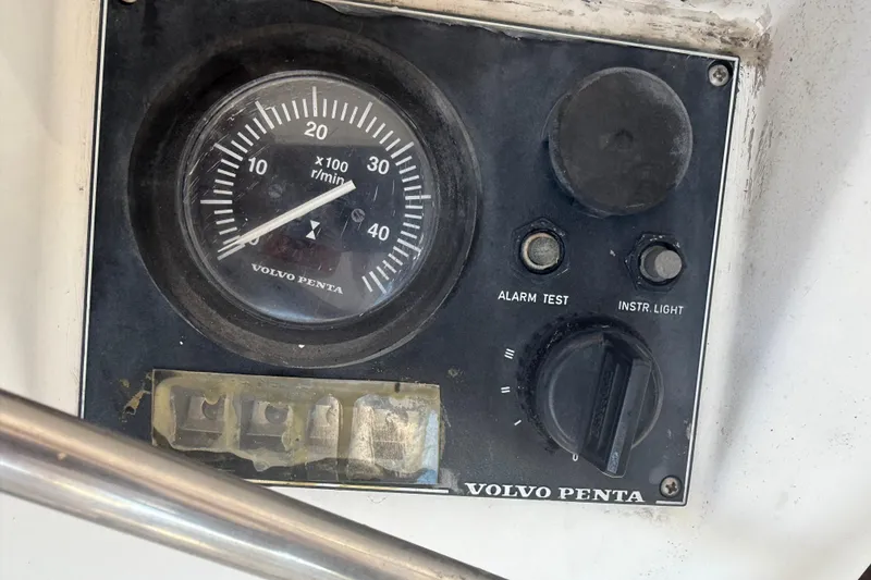 Slide: The Image of Volvo Penta control panel on 1995 Manta Sailing Catamaran, featuring tachometer and switches. - 79