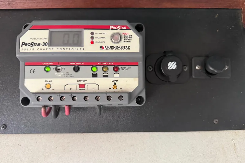 Slide: The Image of ProStar-30 solar charge controller on 1995 Manta SAILING CATAMARAN, displaying battery and solar status. - 81