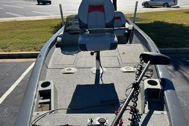 Slide: The Image of 2016 Bass Tracker 175 TF fishing boat with seating and trolling motor in a parking lot. - 3