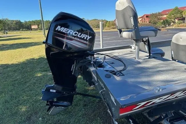 Slide: The Image of 2016 Bass Tracker 175 TF boat with Mercury outboard motor, parked on grass. - 4