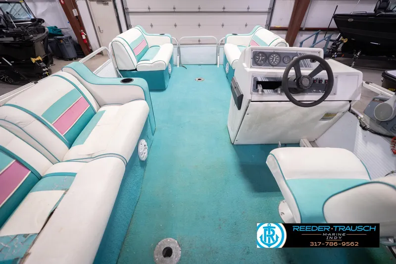 Slide: The Image of Interior of a 1993 Avalon Playbouy Challenger boat with teal and pink seating. - 18