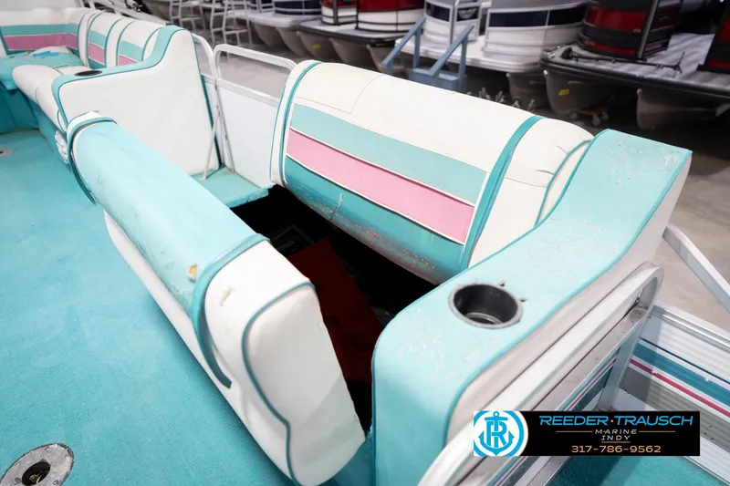 Slide: The Image of 1993 Avalon Playbouy Challenger boat interior with teal and pink seating, Reeder-Trausch Marine logo visible. - 22