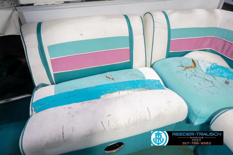 Slide: The Image of Worn 1993 Avalon Playbouy Challenger boat seats with teal and pink accents, showing visible damage. - 25