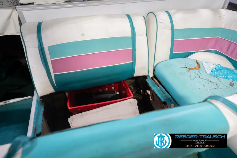 Slide: The Image of 1993 Avalon Playbouy Challenger boat interior with worn teal and pink seating. - 26