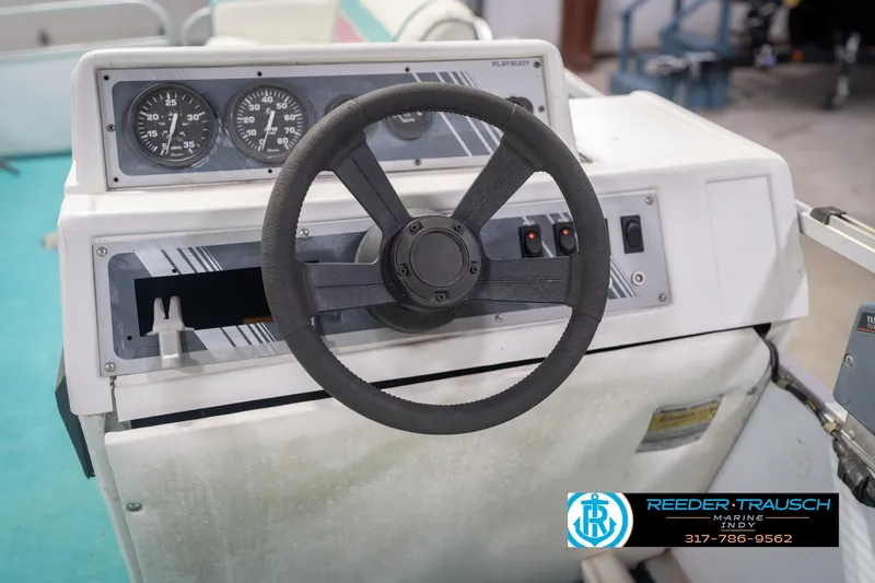Slide: The Image of Steering console of a 1993 Avalon Playbouy Challenger boat with gauges and controls. - 28