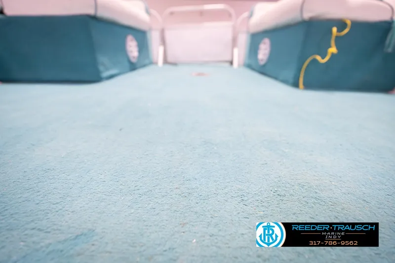 Slide: The Image of 1993 Avalon Playbouy Challenger boat interior with blue carpet and seating. - 39