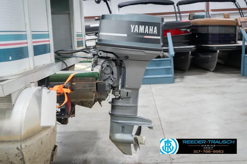 Slide: The Image of 1993 Avalon Playbouy Challenger with Yamaha outboard motor in a showroom. - 40