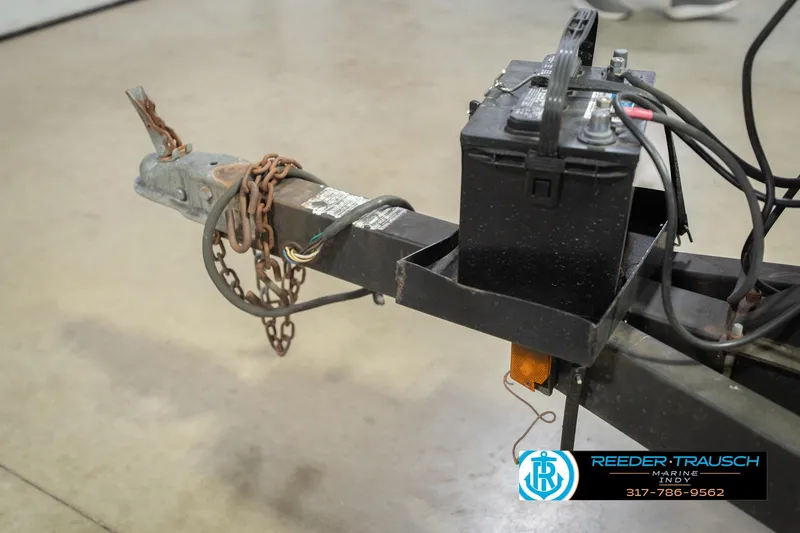 Slide: The Image of Trailer hitch and battery of 1993 Avalon Playbouy Challenger with chains and wiring. - 45