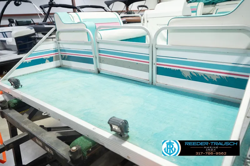 Slide: The Image of 1993 Avalon Playbouy Challenger pontoon boat interior with teal and pink accents. - 47