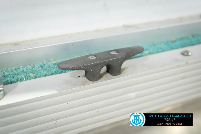 Slide: The Image of Close-up of a 1993 Avalon Playbouy Challenger boat cleat on a textured surface. - 48