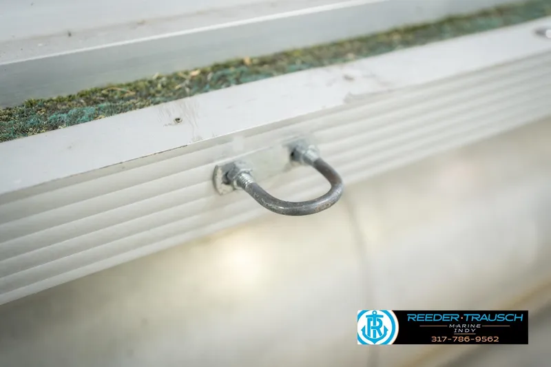 Slide: The Image of Close-up of 1993 Avalon Playbouy Challenger boat detail with metal hook and textured surface. - 49