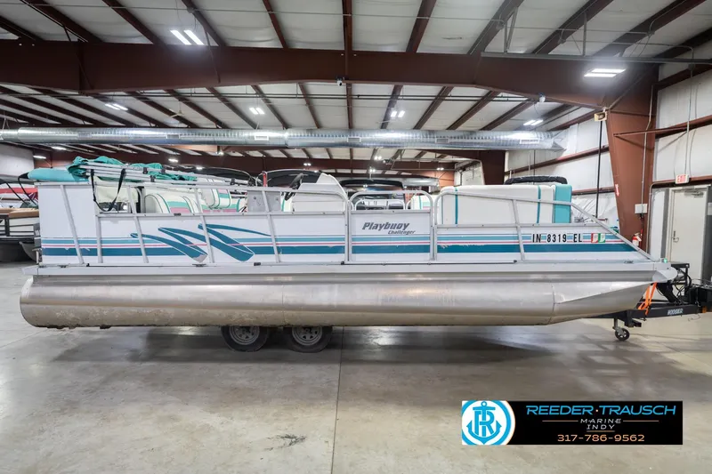 Slide: The Image of 1993 Avalon Playbouy Challenger pontoon boat in indoor storage facility. - 6