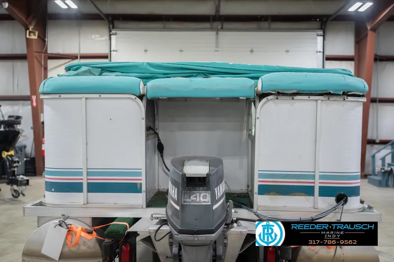 Slide: The Image of 1993 Avalon Playbouy Challenger pontoon boat with Yamaha motor in a warehouse setting. - 8