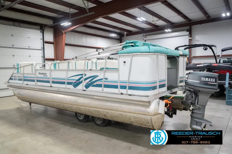 Slide: The Image of 1993 Avalon Playbouy Challenger pontoon boat with Yamaha motor in a warehouse setting. - 9