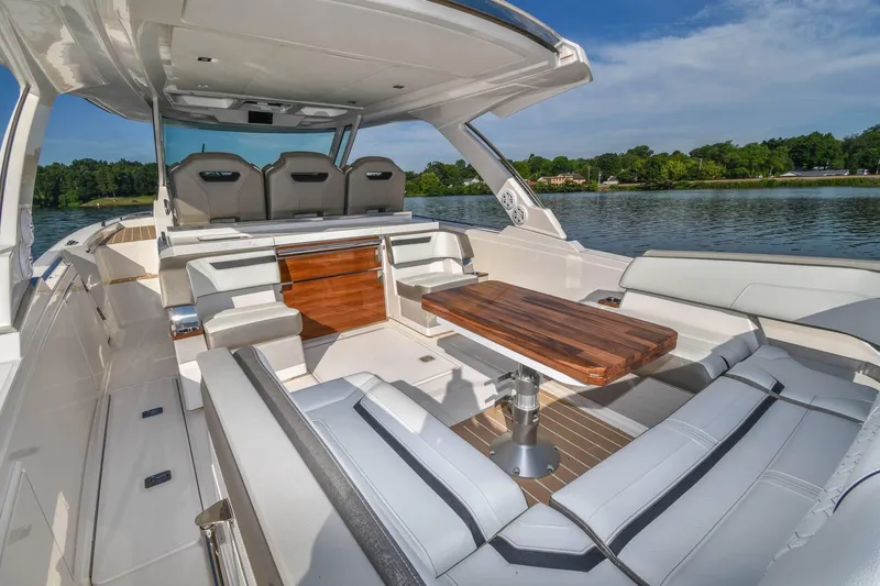 Slide: The Image of 2024 Tiara Yachts 38 LS luxury boat interior with elegant seating and wooden table. - 15