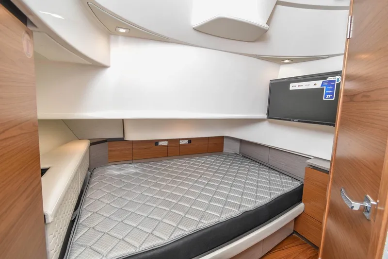 Slide: The Image of 2024 Tiara Yachts 38 LS cabin interior with bed and TV, featuring modern design. - 30
