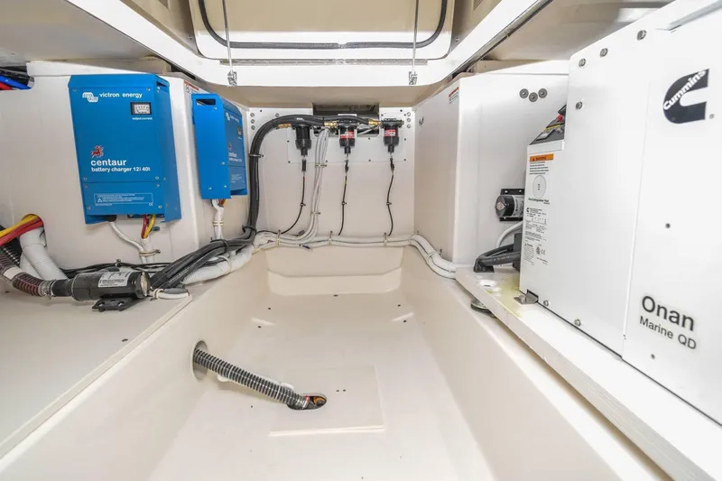 Slide: The Image of 2024 Tiara Yachts 38 LS engine room with Victron Energy chargers and Onan Marine QD generator. - 31
