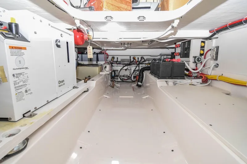 Slide: The Image of Engine compartment of 2024 Tiara Yachts 38 LS, featuring Onan generator and electrical systems. - 32