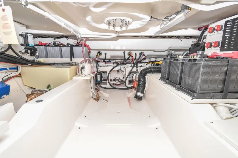 Slide: The Image of Engine compartment of 2024 Tiara Yachts 38 LS, showcasing wiring and battery setup. - 33