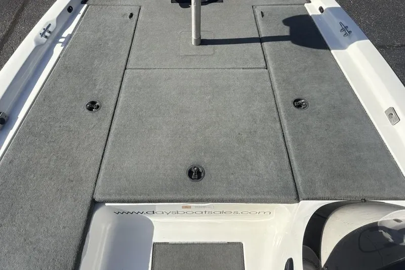 Slide: The Image of 2004 Stratos 285 Pro XL boat deck with gray carpet and storage compartments. - 10