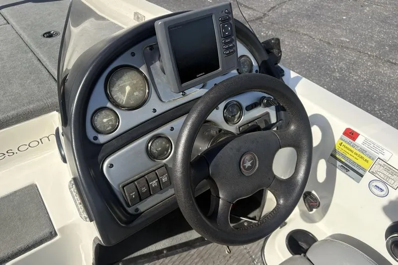 Slide: The Image of 2004 Stratos 285 Pro XL boat dashboard with steering wheel and gauges. - 17
