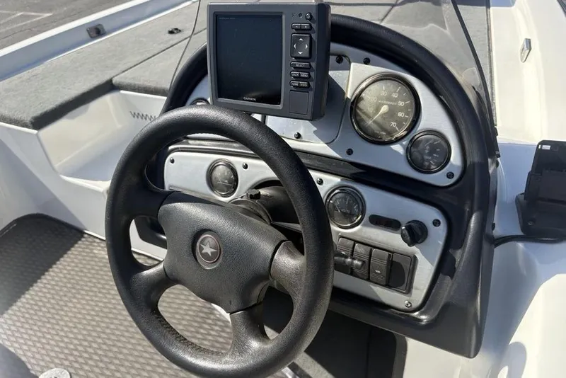 Slide: The Image of 2004 Stratos 285 Pro XL boat dashboard with steering wheel and gauges. - 21