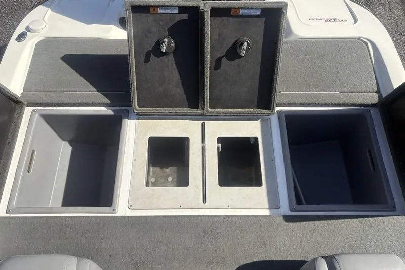 Slide: The Image of 2004 Stratos 285 Pro XL boat storage compartments with open lids. - 22
