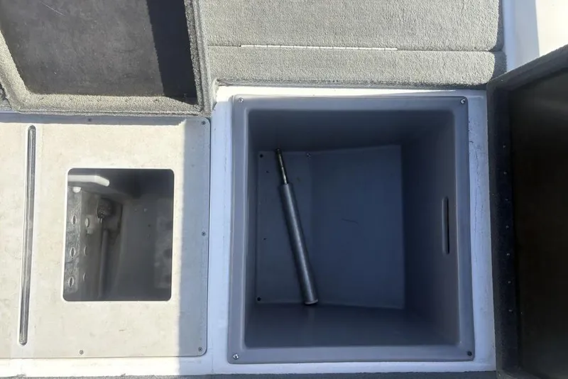 Slide: The Image of Open storage compartments on a 2004 Stratos 285 Pro XL boat deck. - 27