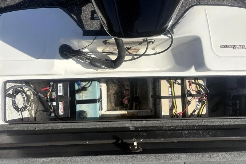 Slide: The Image of 2004 Stratos 285 Pro XL boat battery compartment with wiring and components. - 30