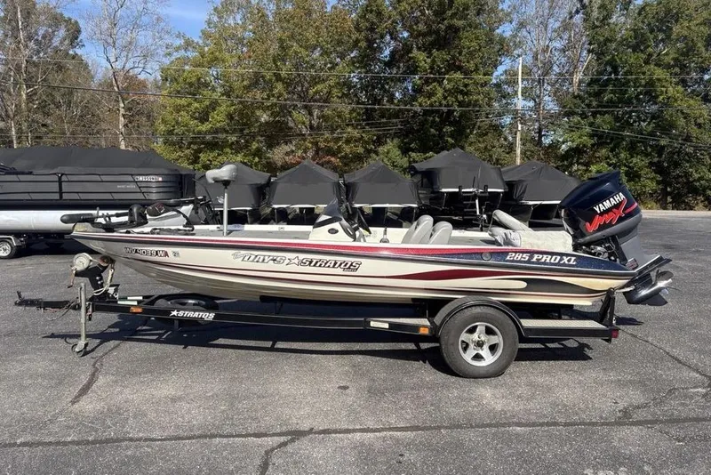 Slide: The Image of 2004 Stratos 285 Pro XL boat with Yamaha engine on trailer, parked outdoors. - 6
