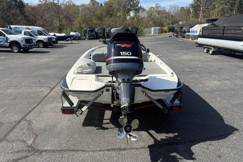 Slide: The Image of 2004 Stratos 285 Pro XL boat with Yamaha 150 outboard motor in a parking lot. - 8
