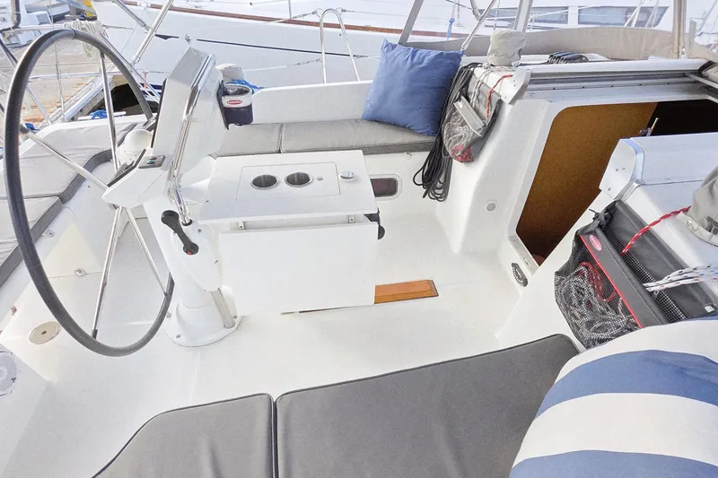 Slide: The Image of Cockpit of 2013 Beneteau Oceanis 37 sailboat with steering wheel and seating area. - 11