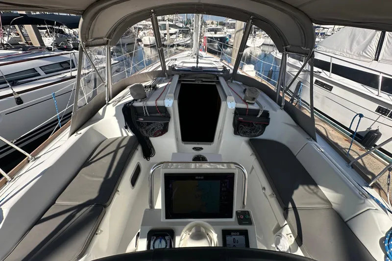 Slide: The Image of Cockpit of 2013 Beneteau Oceanis 37 sailboat, featuring navigation equipment and seating. - 13