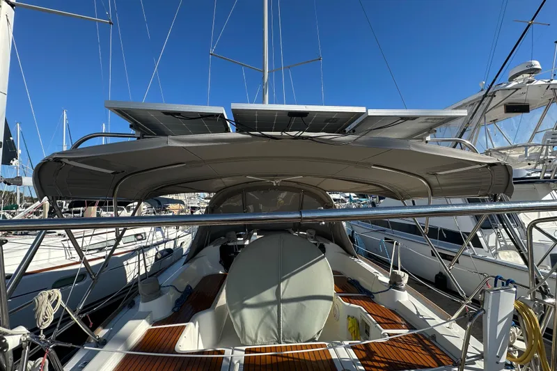 Slide: The Image of 2013 Beneteau Oceanis 37 sailboat with solar panels, docked in a marina. - 17