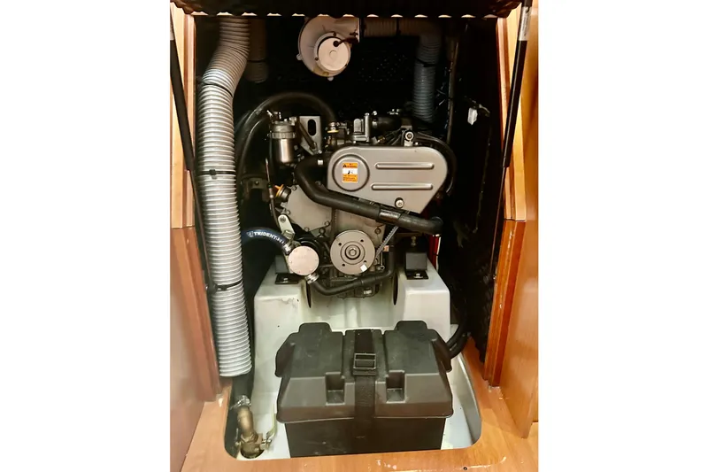 Slide: The Image of Engine compartment of a 2013 Beneteau Oceanis 37 sailboat, showcasing mechanical components. - 23