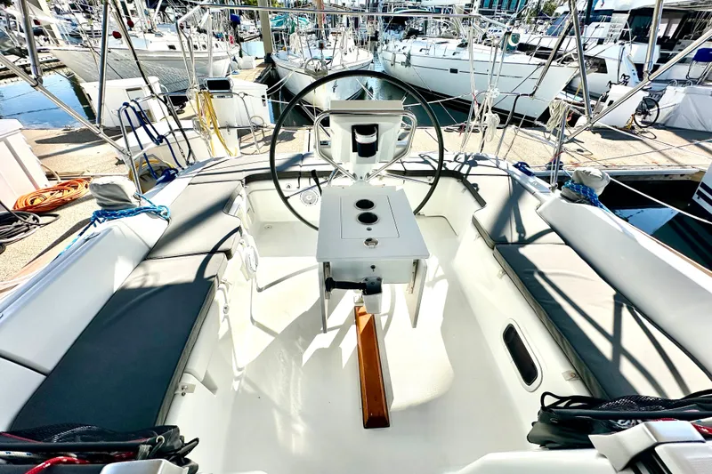 Slide: The Image of 2013 Beneteau Oceanis 37 sailboat cockpit with steering wheel and seating at marina. - 26